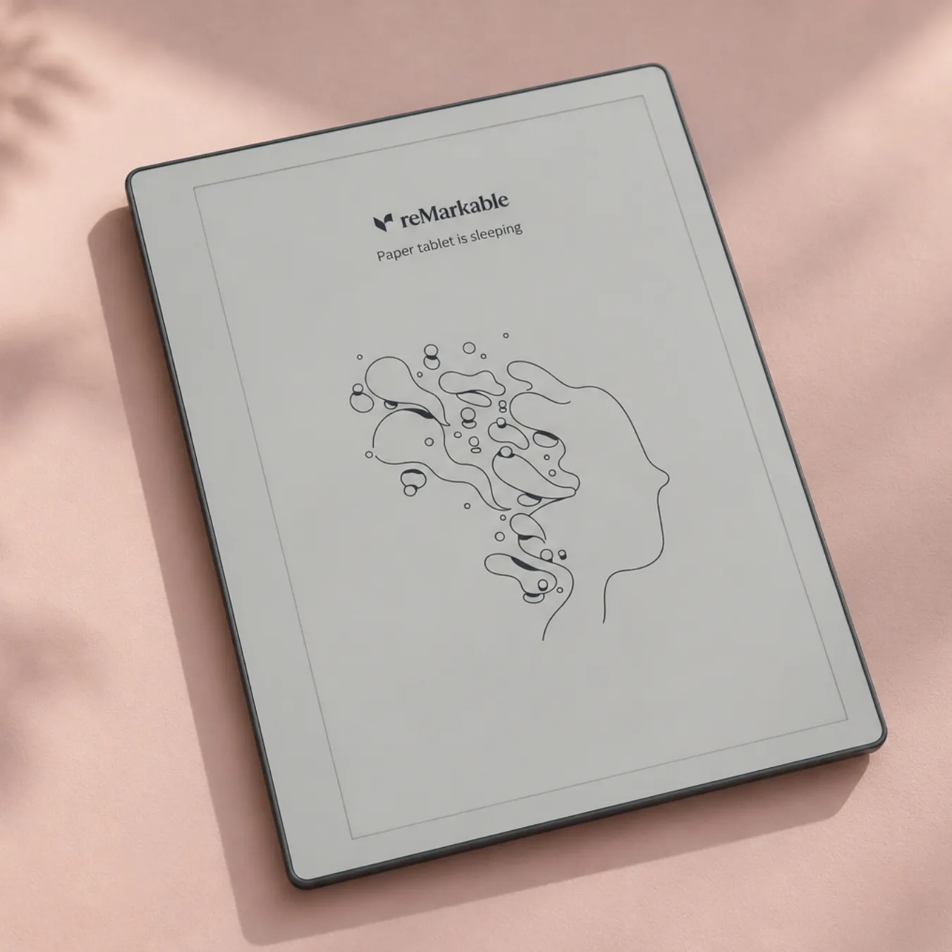 reMarkable Paper Pure showing its sleep screen, on a pink background