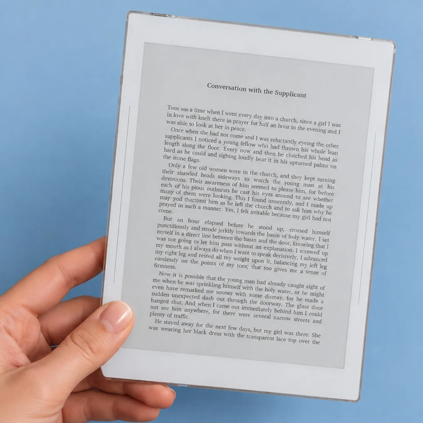 Supernote Nomad held in one hand with a book page on screen, on a blue background